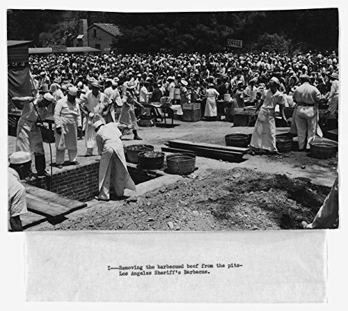 0011765436287 - 1930 PHOTO REMOVING THE BARBECUED BEEF FROM THE PITS, LOS ANGELES SHERIFF'S BARBECUE PHOTOGRAPH SHOWING CREW OF BARBECUE COOKS AROUND A BRICK-LINED PIT, WITH SERVERS AND CROWD IN THE BACKGROUND. LOCAT