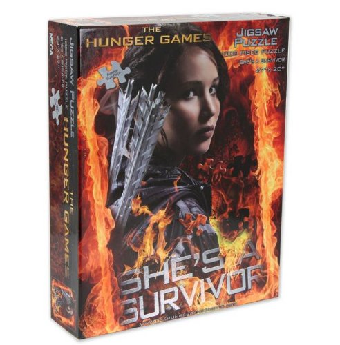 0634482261064 - THE HUNGER GAMES MOVIE PUZZLE JIGSAW PUZZLE SHES A SURVIVOR
